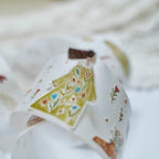 Baby blanket with a house design on a soft surface
