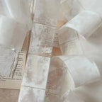 Close-up of a white fabric with a textured pattern on a light background