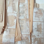 Stack of old, worn-out books with text on a textured surface