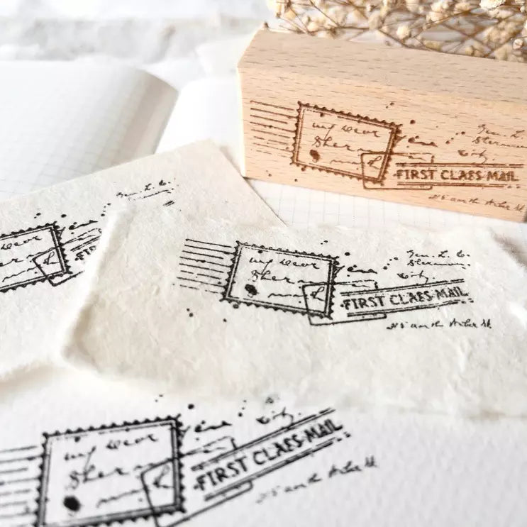 First Class Mail Rubber Stamp vintage postage prints styled on tea bags on a white surface