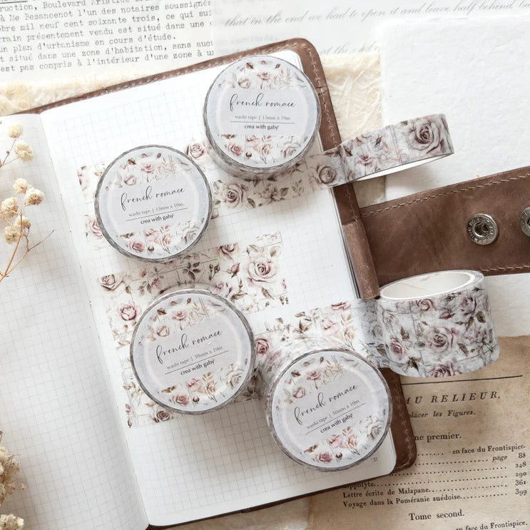 Small containers with French Romance Floral Washi Tape labels styled on an open book