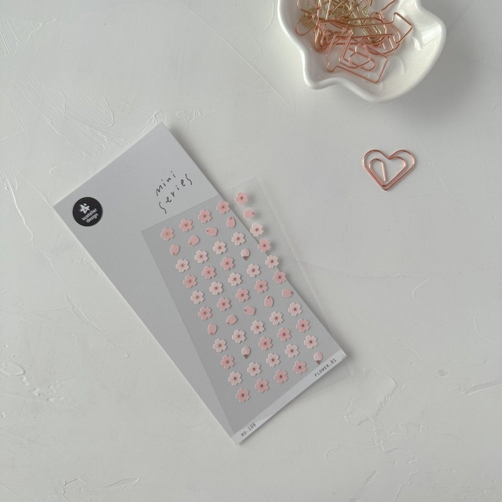 Floral sticker sheet with a heart-shaped paperclip on a light gray background