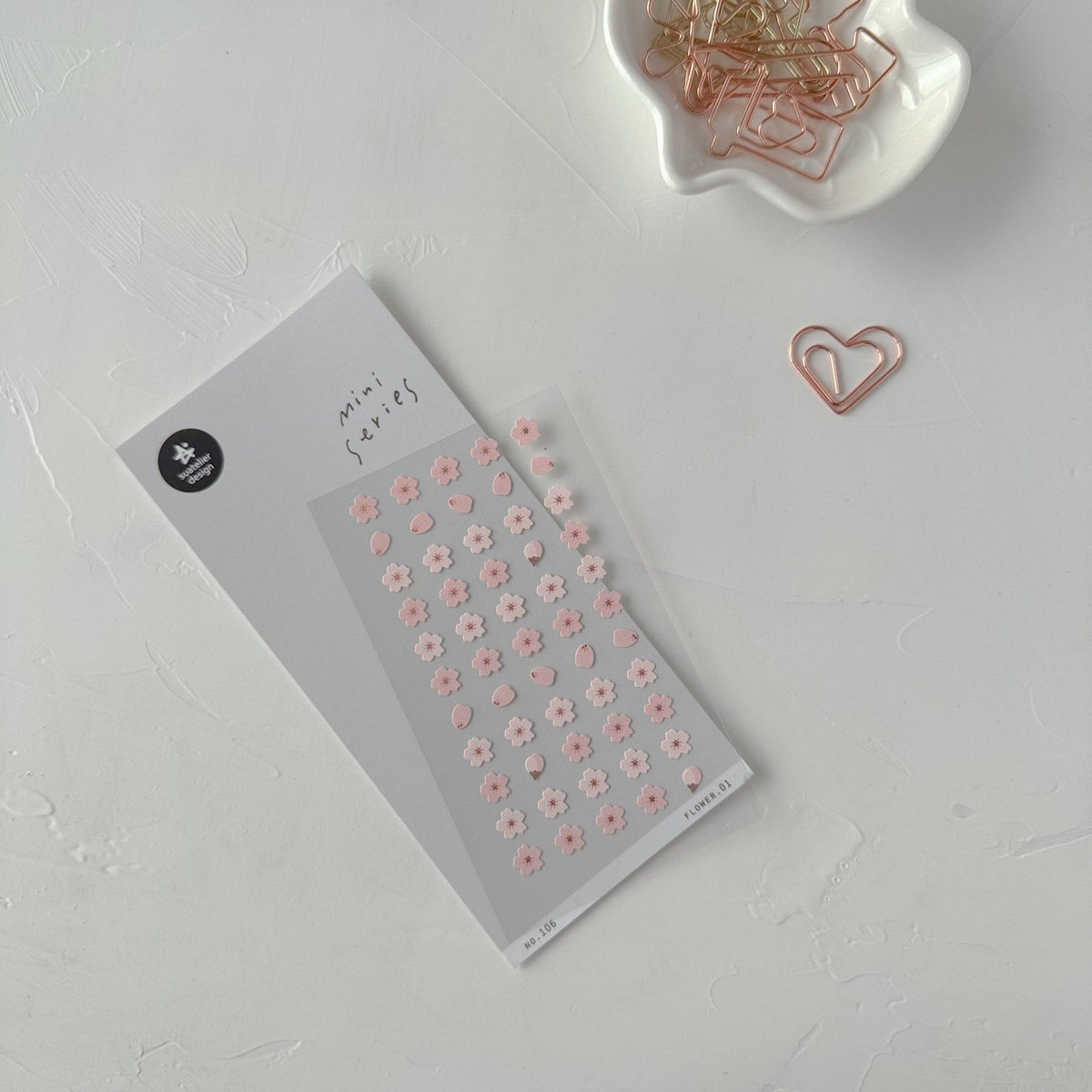 Flower 01 Sticker Sheet by Suatelier, floral stickers with a heart-shaped paperclip on a light grey background