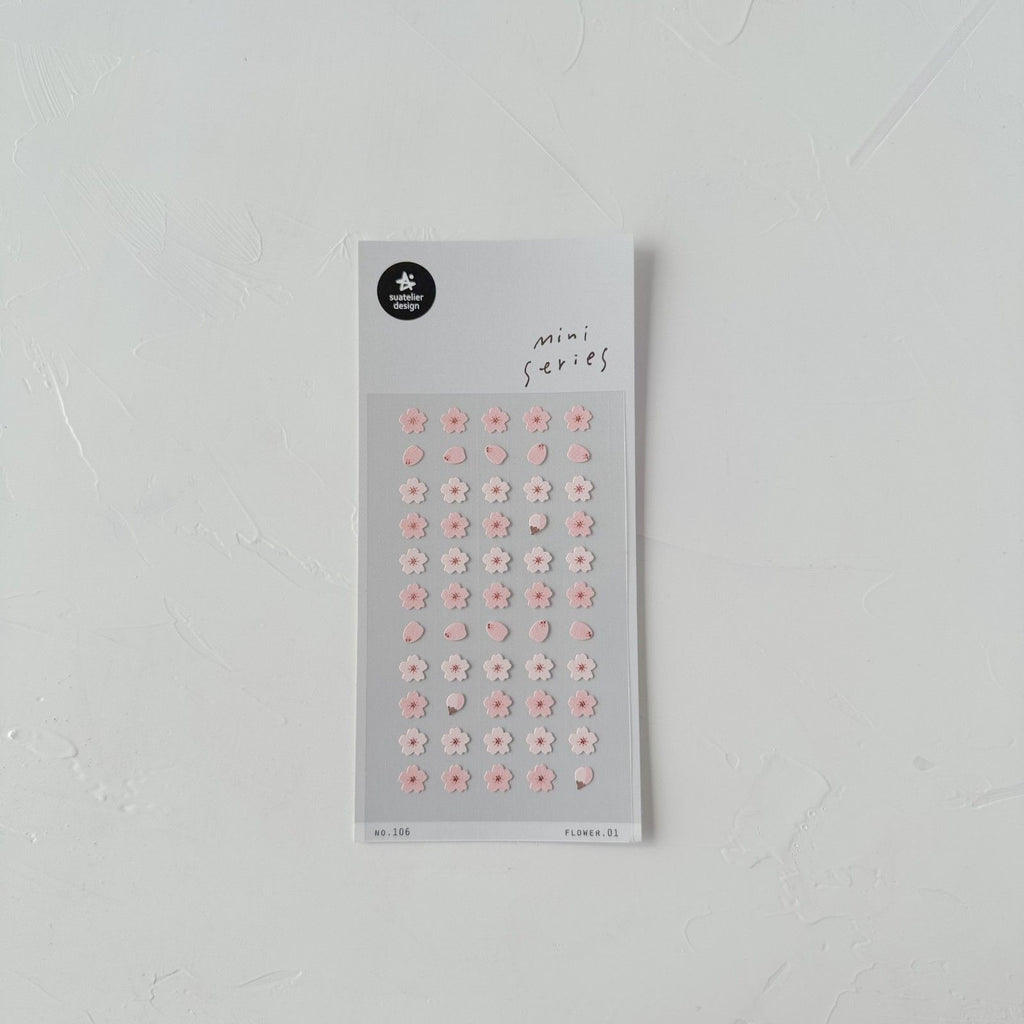 Sheet of small floral stickers on a gray background