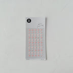 Sheet of small floral stickers on a gray background