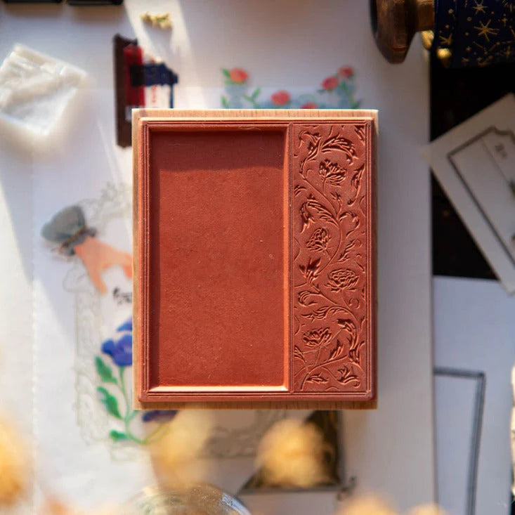 Flower Frame A Rubber Stamp wooden block with floral embossing on a softly blurred background