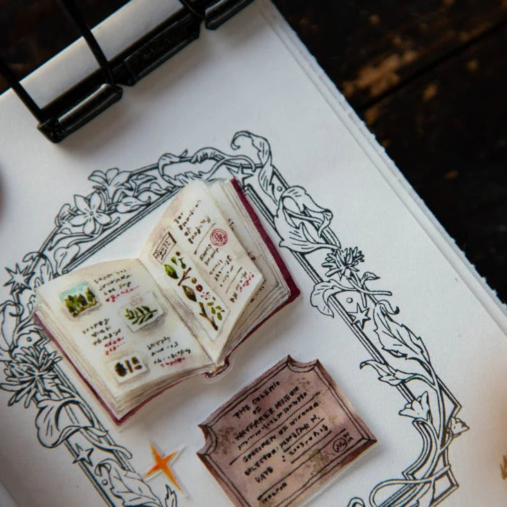 Small open book stamped with Flower Frame B Rubber Stamp botanicals on a decorative backdrop