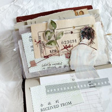 Open book with vintage pages decorated with Flower Haired Boy PET Tape text and images