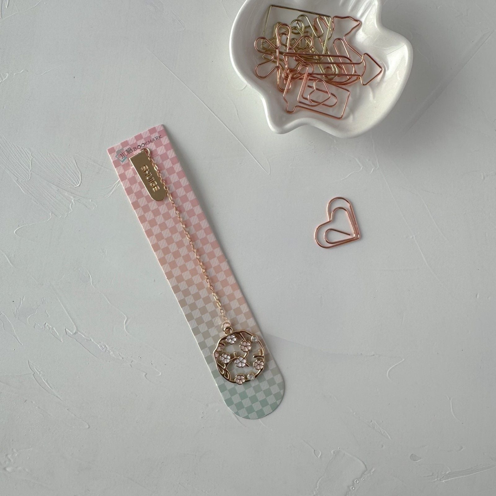 Decorative bookmark with decorative pen on a light gray background