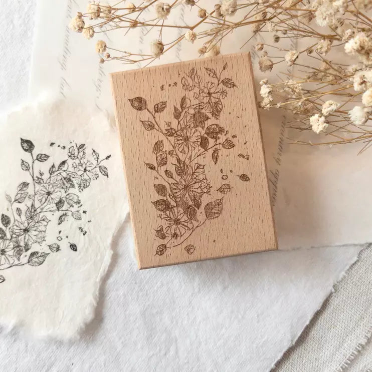 Flowers in My Journal Rubber Stamp with floral design and dried flowers on a white surface