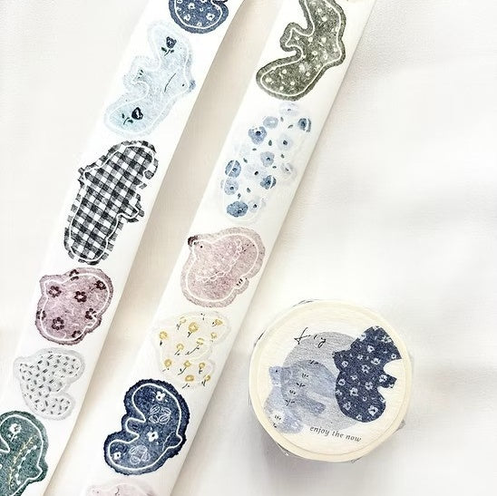 Rolls of decorative paper with various patterns on a white background