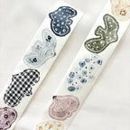 Two rolls of decorative tape with various patterns on a white background