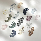 Collection of decorative animal-shaped ornaments on a light background