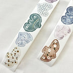 Two rolls of decorative tape with floral designs on a light background