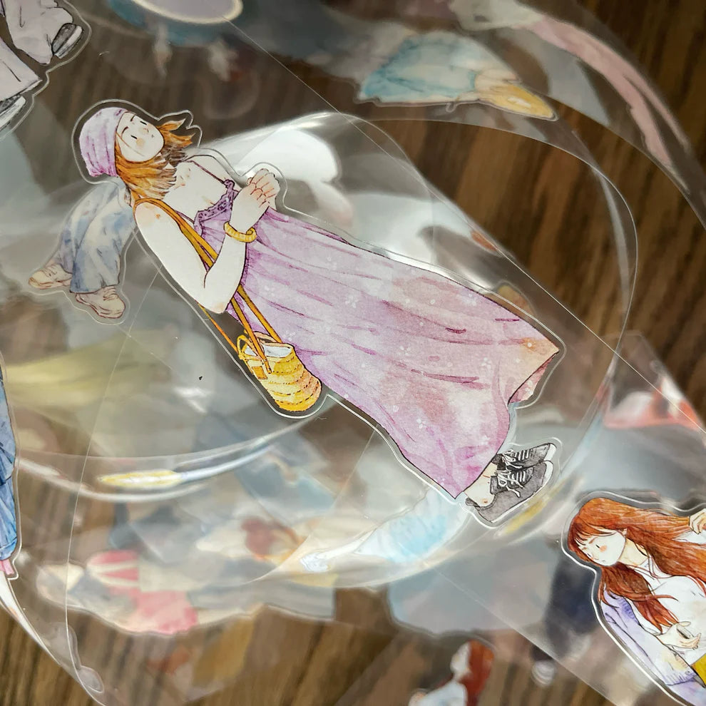 Decorative glass item with artistic illustrations of people on a reflective surface.