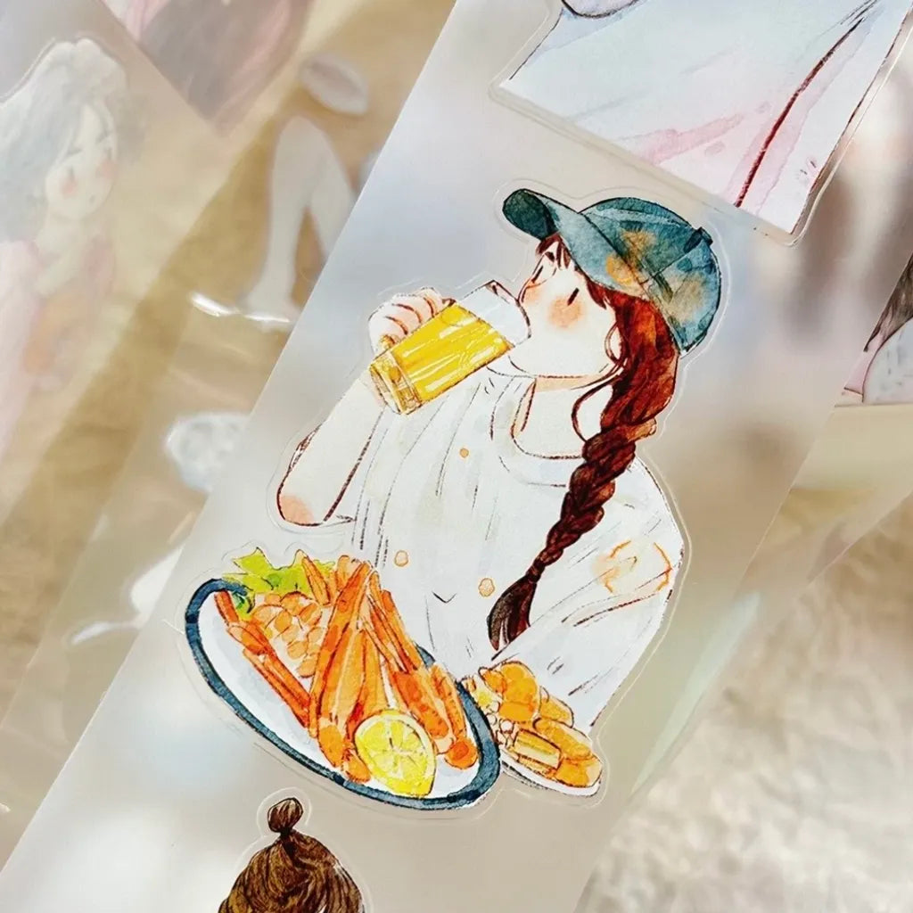 A close-up of a transparent or frosted sticker sheet featuring an illustrated girl with a long braid drinking from a yellow cup, with plates of food in front. The sheet is photographed on a soft, light-colored surface with other partial stickers visible around it.