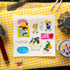 Set of colorful stickers on a white card with decorative elements on a yellow checkered background.