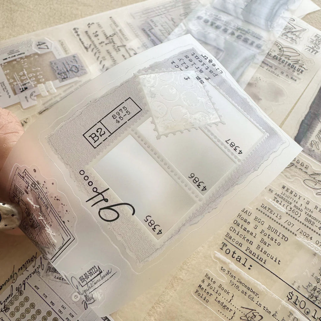 Collection of clear stamps with various designs and text on a textured surface.