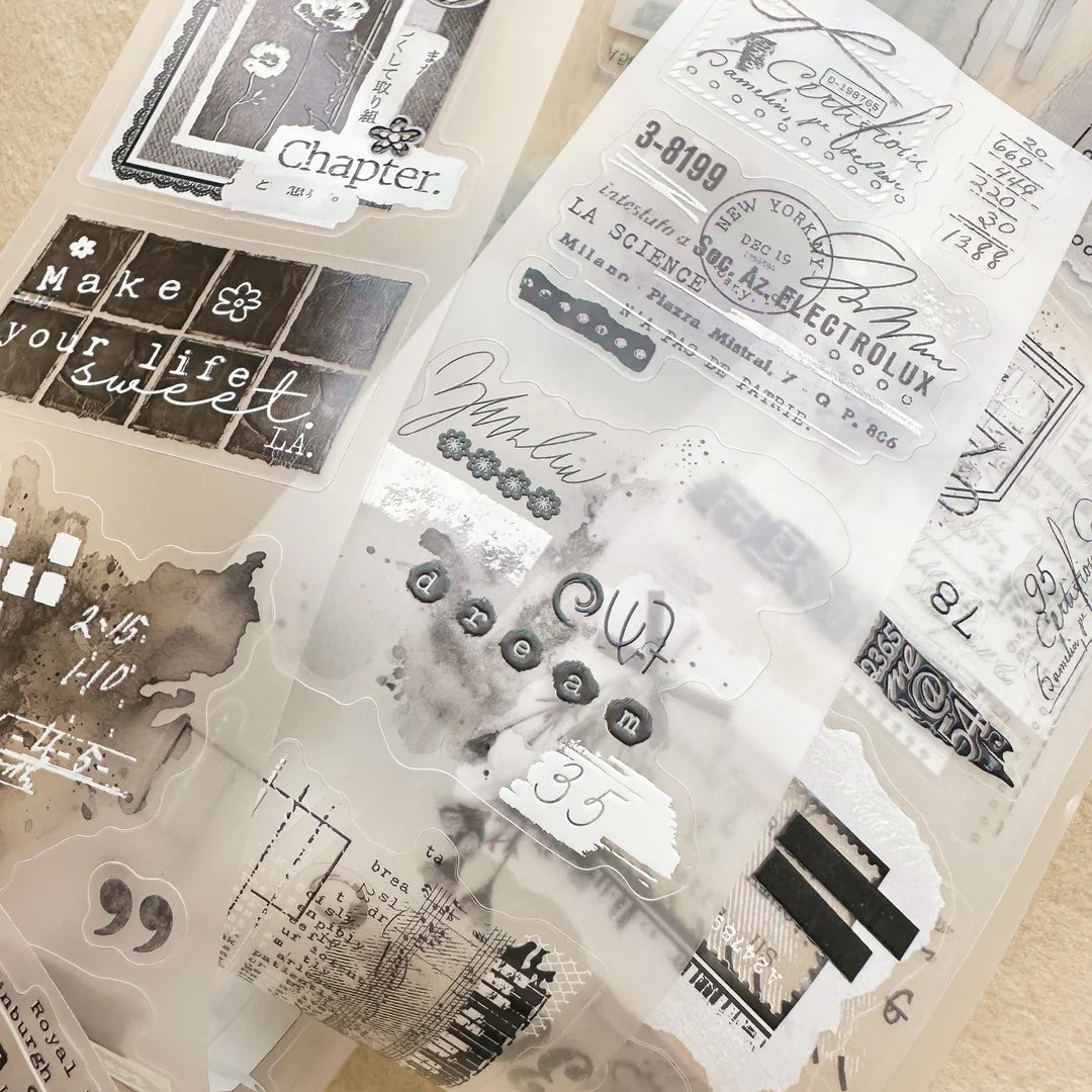 Fragment Crystal PET Tape assorted text and design pieces laid out on a beige background