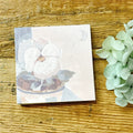 Notebook with floral design on a wooden surface with hydrangeas