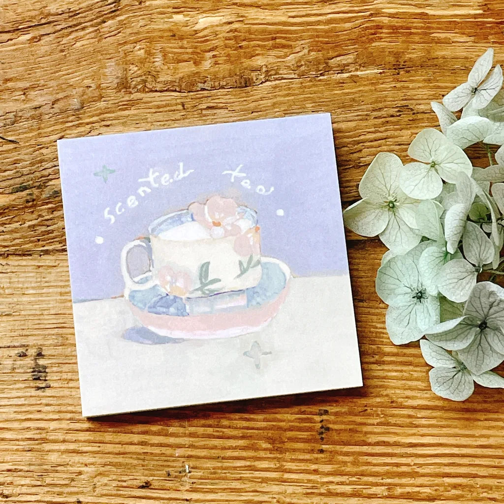 Scented Tea Memo Pad by Freckles Tea with a teacup illustration on wood with fresh flowers