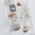 Set of floral and nature-themed stickers on a textured white background