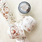 Three rolls of decorative tape with floral designs on a light surface