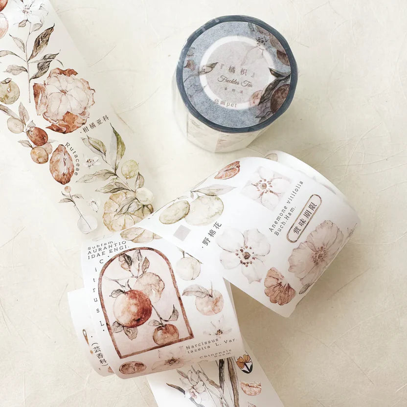 Three rolls of Freckles Tea Vol.3 Citrus Washi Tape with floral designs on a light surface