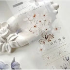 Decorative wall piece with floral design and text on a white background