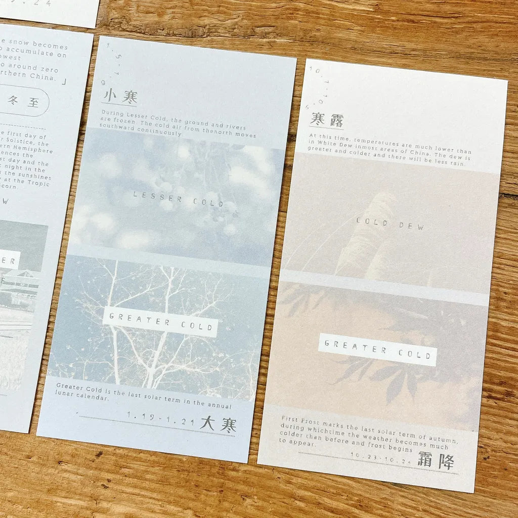 Set of four leaflets with text and minimalistic designs on a wooden surface