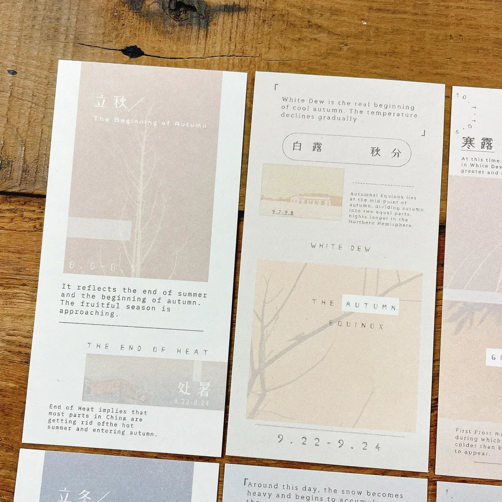 Set of cards with text and minimalistic designs on a wooden surface