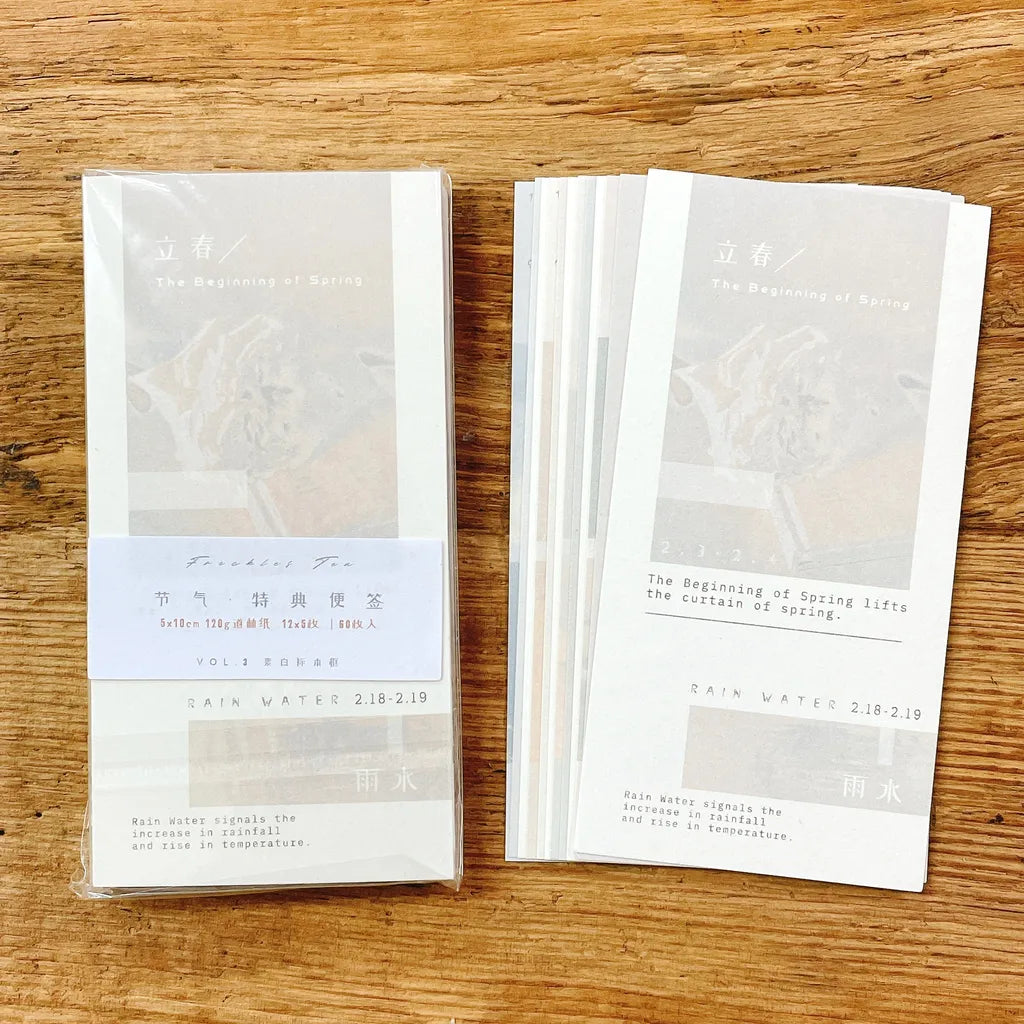 White Solar Terms Memo Pad Vol. 3 cards with printed text laid on a wooden surface