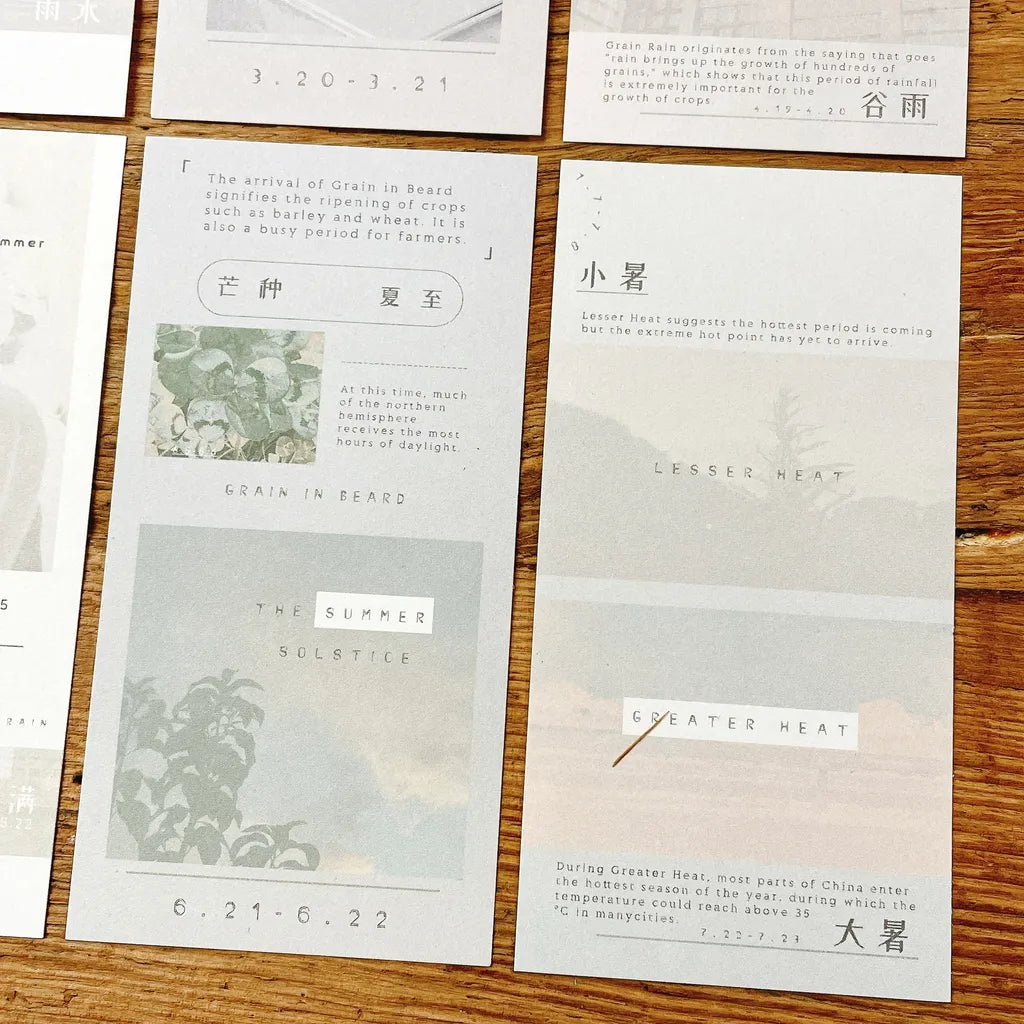 Spread of Solar Terms Memo Pad Vol. 3 cards showing their minimalist designs on wood
