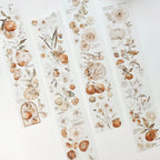 Decorative paper strips with floral and fruit patterns on a white background