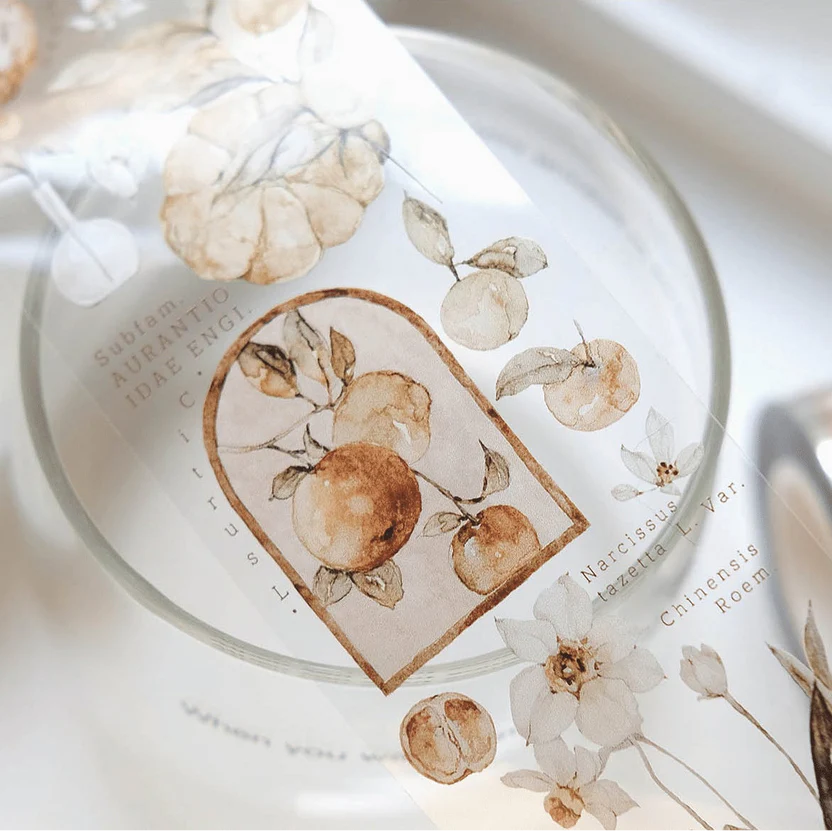 Glass decorated with a Tangerine PET Tape floral design displayed on a white surface