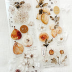 Decorative sticker sheet with pears and flowers on a textured white background