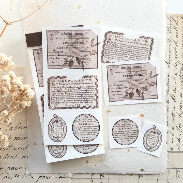 Flat lay of French Labels Crafting Memo Pad vintage labels with handwritten paper and flowers