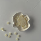 White plastic mold with a star design on a gray surface