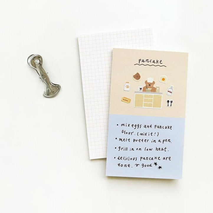 Notebook with a cartoon bear illustration and recipe text, from the Ggumi Home Sticker Sheet