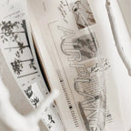 Stack of books with visible text and images on a light background