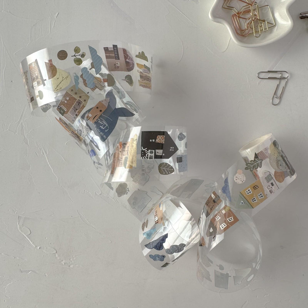 Good Building Art Collage Room PET Tape in clear packaging with question-mark die cuts on grey