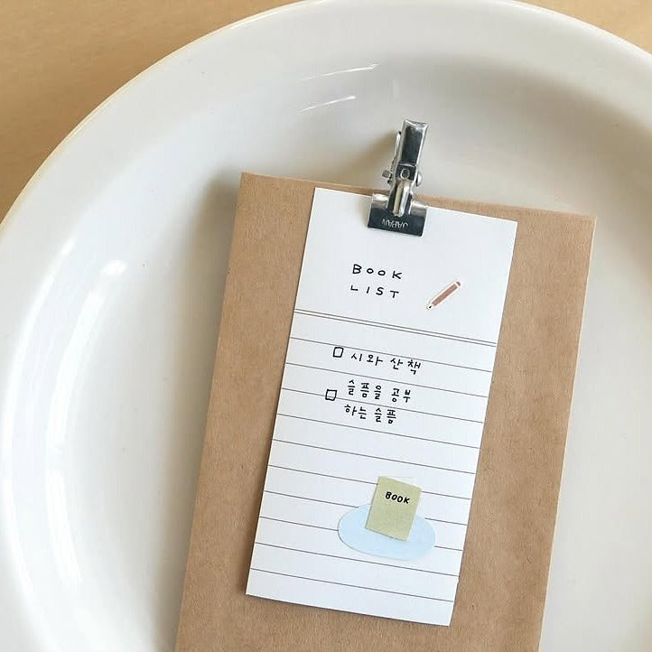 Notebook with a clip holding a 'Book List' page on a white plate, from the Good Night Sticker Sheet
