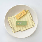 Set of recipe cards with small labels on a white plate