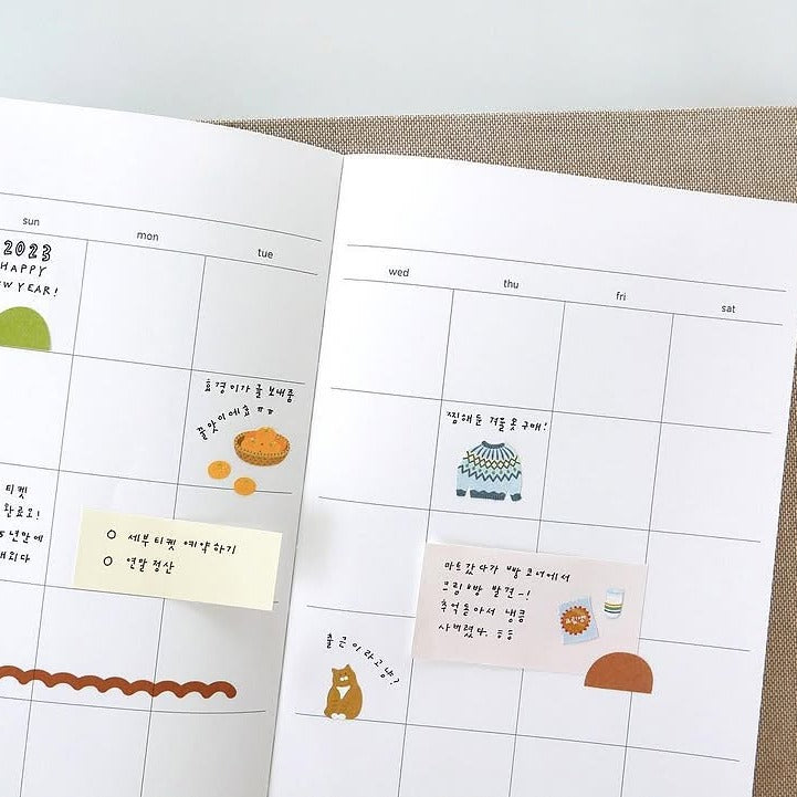 Open planner with calendar pages and decorative stickers, from the Grandpa's Room Sticker Sheet