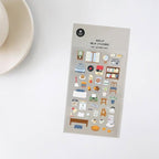 Sheet of decorative stickers with various small illustrations on a white surface