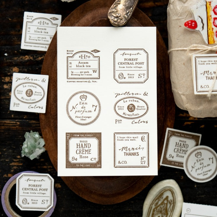 Grocery Labels Letterpress Memo Pad vintage label assortment with a pen on a wooden surface