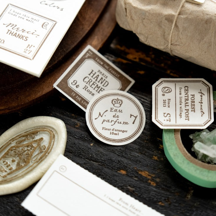 Grocery Labels Letterpress Memo Pad styled as vintage packaging with a small bottle on dark