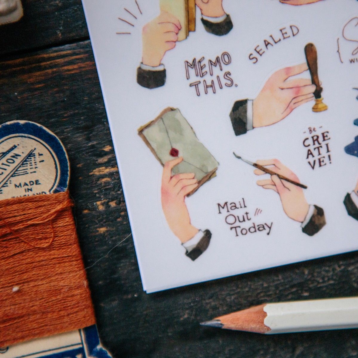 Card decorated with Hands Transfer Sticker hand illustrations and text on a wooden surface