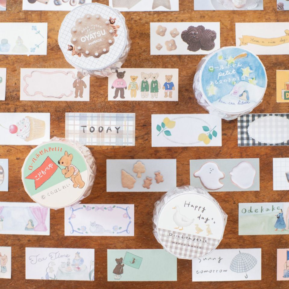 Collection of Happy Day Sticky Memo Label Sticker Tape designs laid on a wooden surface