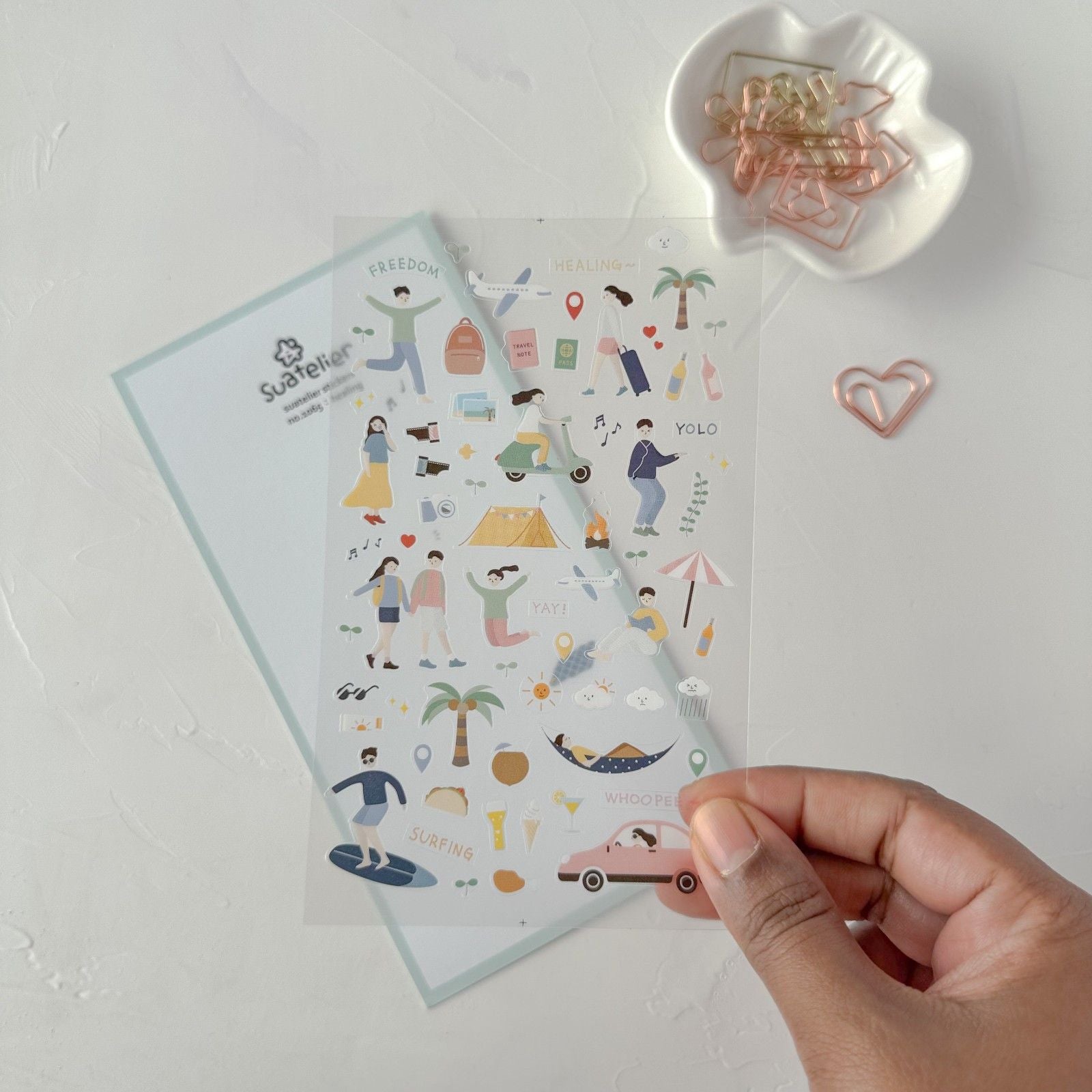 Healing Sticker Sheet held up to show the illustrated stickers, alternate angle